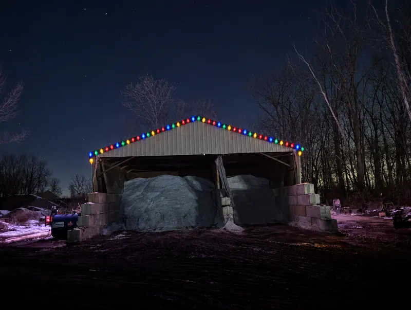 Pole barn with multicolor lights along the peak