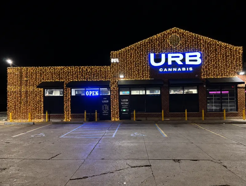 Commercial building covered in warm white lights with a lit sign
